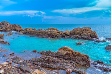 Fototapeta na wymiar Fresh air at the sea Beautiful stones being beaten by waves.