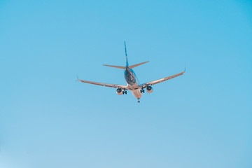 Fototapeta na wymiar San Diego, USA, 2018. Airliner in blue sky. Travel, air transportation concept