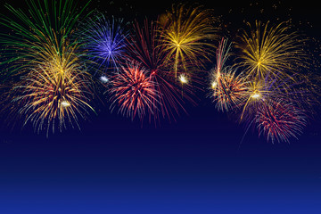 Fototapeta na wymiar Colorful fireworks celebration on the twilight sky.