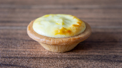 Cheese baked tart on wooden background