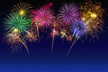 Colorful fireworks celebration on the twilight sky.