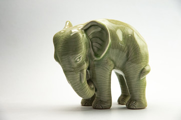 Fototapeta na wymiar Charming green porcelain elephant isolated on white background.