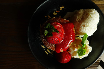 Top view of pancake with strawberry and ice cream dessert