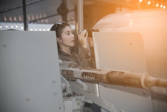 Pretty Asian Female Soldier Looking With Binoculars On A Ship..