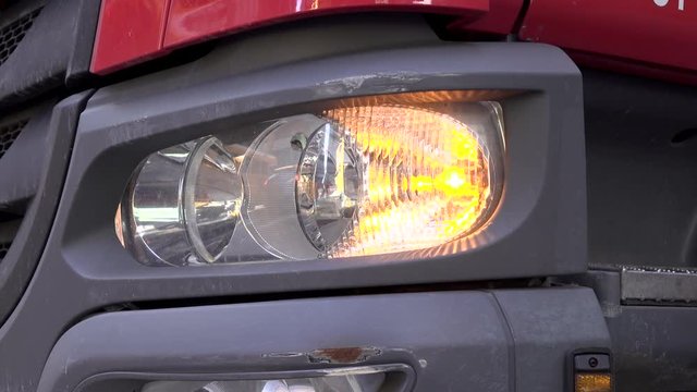 Semi truck with hazardous flashers blinking in city 4k