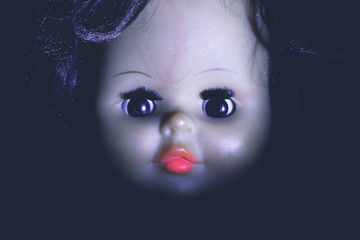 Portrait vintage spooky devil doll.