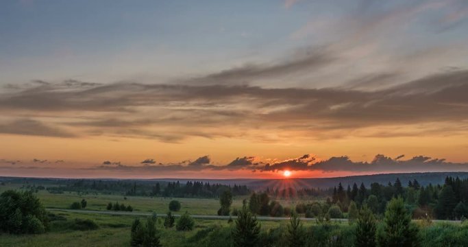 Beautiful evening sunset landscape with a span of time, forest and river in the distance