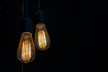Closeup of light bulb is on with dark background