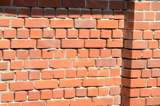 Weather eroded red brickstone wall