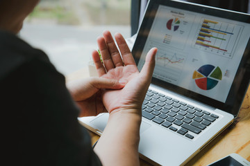 Man holding his wrist close-up . Pain from using computer. Office syndrome hand pain by occupational disease.