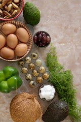 keto diet.low carb diet.Avocados, olives, olives, nuts, chicken and quail eggs, kokos, kokos oil, dill and pepper on a  marble background.High fat food.Ketogenic Diet.