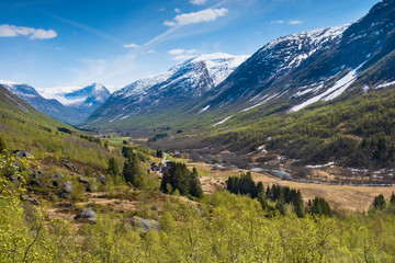 Fototapeta na wymiar Spring landscape mountain valley with snow covered peaks in Norway