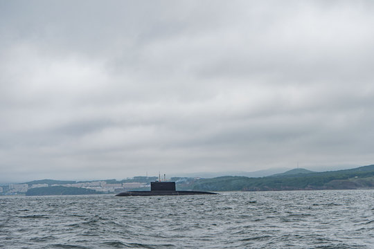 A line of modern russian military submarine cruisers in the row, northern fleet and baltic sea fleet in the open sea, submarine