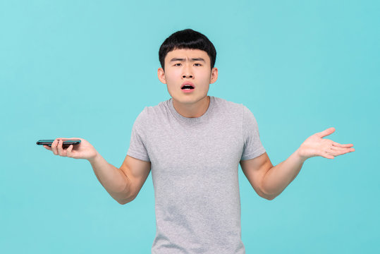 Unhappy Asian man having trouble with his smartphone