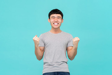 Asian man raising his fists doing yes gesture