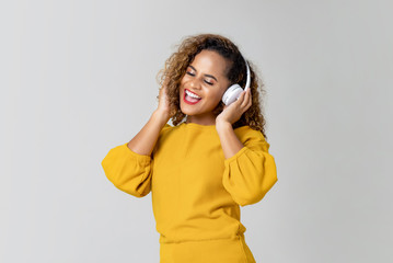 Happy woman listening to music from headphones