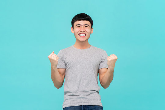 Asian Man Raising His Fists Doing Yes Gesture