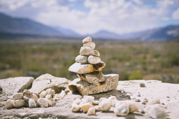 Pile stacked of zen stones or rocks with beautiful mountain in leh, Ladakh, Jammu and Kashmir, India.