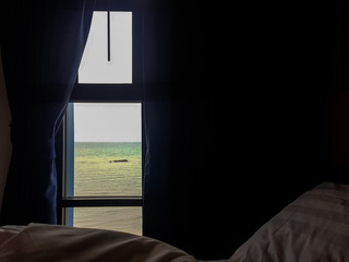 man looking at window in room