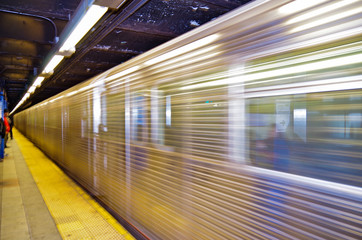 Blurred silver New York subway train at platform