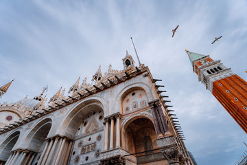 Detail of the bell tower Campanile di San Marco and the cathedral Cattedrale of St. Mark in Venice...