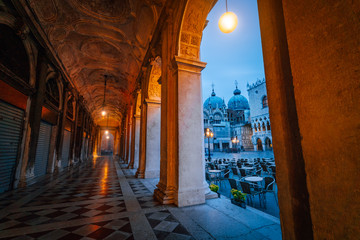 Evening view of Basilica di San Marco and Campanile through the street arch hallway on San Marco in...
