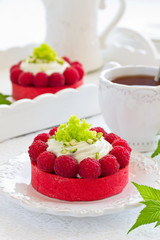 Tartlets with pistachio cream and raspberries.