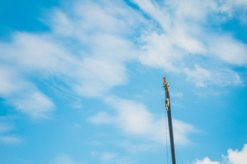 Obraz premium Hydraulic Mobile Crane against the blue sky and clouds. Industrial concept with copy space for wallpaper.