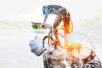 Double exposure of a man in protective helmet and professional cyclist riding on the mountains....