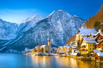 Classic postcard view of famous Hallstatt lakeside town in the Alps with traditional passenger ship...