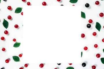 Fruit pattern made of fresh berries, green leaves and frame on white background. Concept of healthy food. Flat lay, top view, copy space