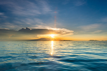 Beautiful beach sunset with blue sea and golden light sky  cloud background