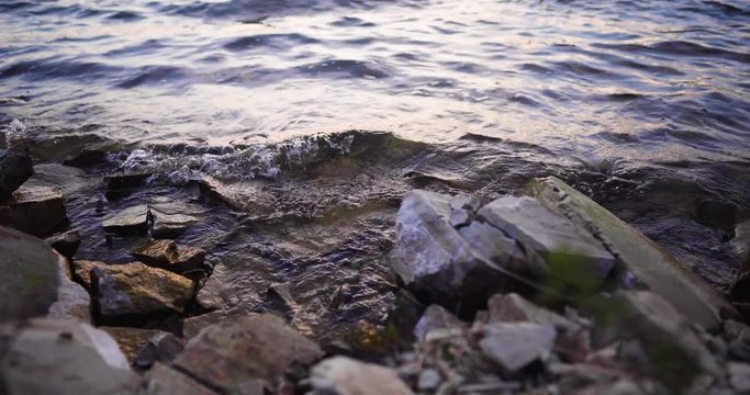 trucking right shot of Lake Cachuma, California, USA timelapse of the water of the lake gently splashing rocky shore
