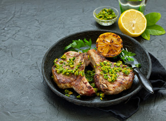 Pork cutlet on a bone with gremolat sauce.