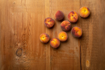 Obraz na płótnie Canvas Fresh ripe peaches fruits on wooden rustic background. Top view.