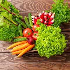 Overhead shot of different vegetables on wooden table