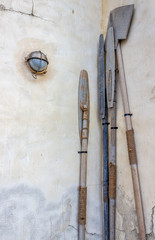 Oars from the Arab boat stand near the wall in the dock.