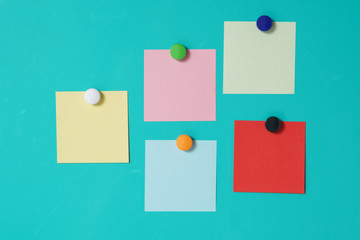 colorful magnet sticky notes on refrigerator door background