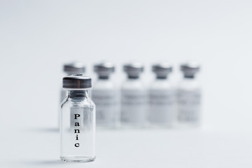 Vaccine with an inscription panic on a white isolated background and a syringe. Close-up.