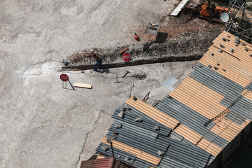 Man at work. Worker digs manually long ditch