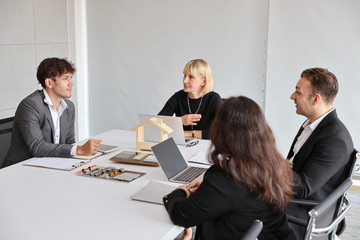 Multiethnic business people discussing company about new house project in meeting room with smiling and happy faces