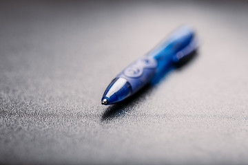 automatic blue plastic ballpoint pen with clipping path on black background. close up.