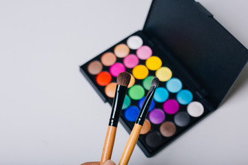 Naklejka premium Bright shadows and make-up brushes. Beauty and Fashion