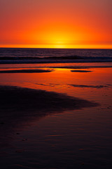 SUNSET WITH HORIZON OF SEA AND SHORE ON THE BEACH IN CADIZ, SPAIN