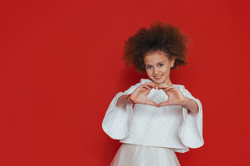 smiling pretty girl with curly hair ON RED
