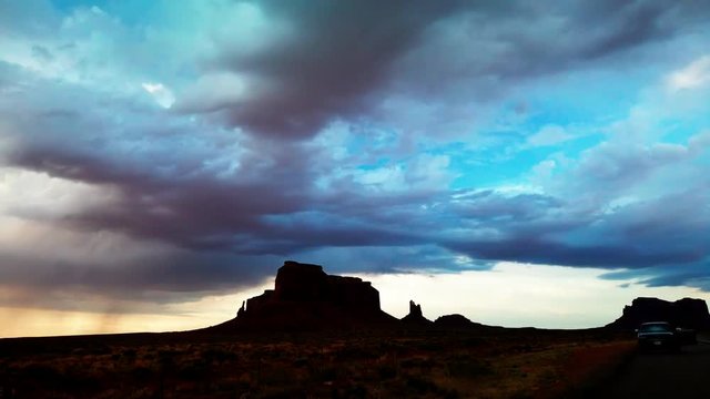 Panning timelapse of Monument Valley at sunset during a thunderstorm. HD