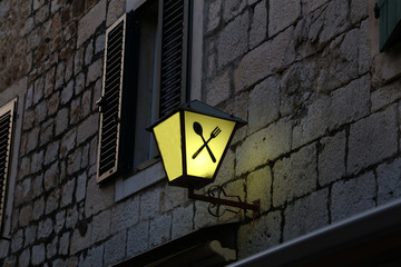 Old street lamps illuminate the way for passersby