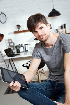 Young man holding tablet