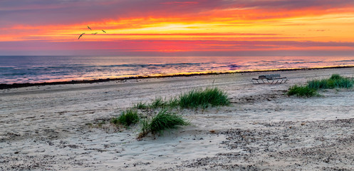Colorful summer sunrise on sandy beach of Jurmala - famous Baltic tourist  resort in Latvia, Europe. Summer vacation concept