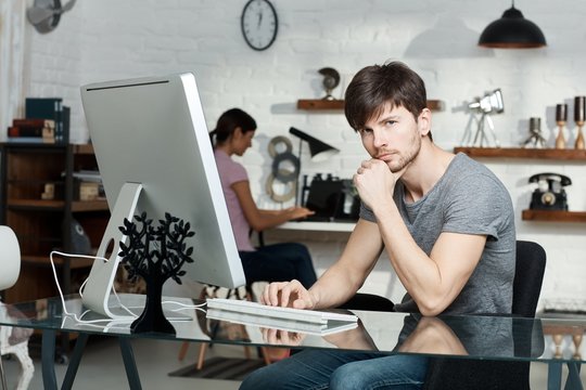 Thoughtful young man working with computer